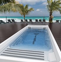 Frontansicht des SwimSpa Wellis Beach Club – luxuriöses SwimSpa in Blau mit Whirlpool- und Poolfunktionen